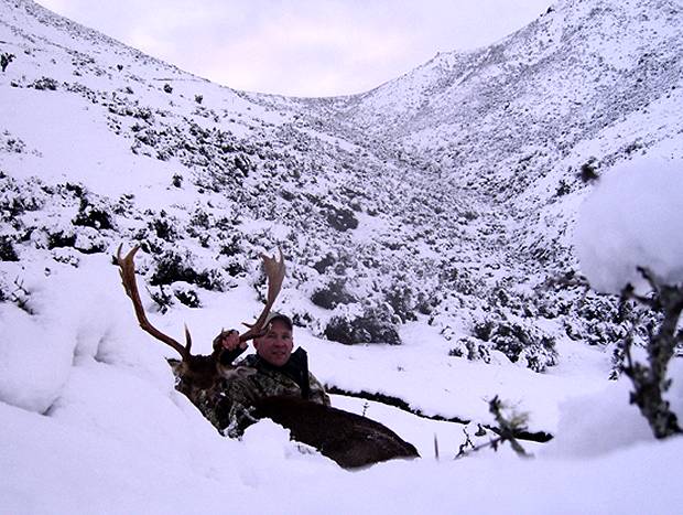 Rodney relaxing in the snow after a long day's hunting.
